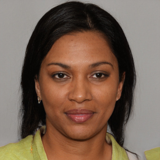 Joyful black young-adult female with medium  black hair and brown eyes