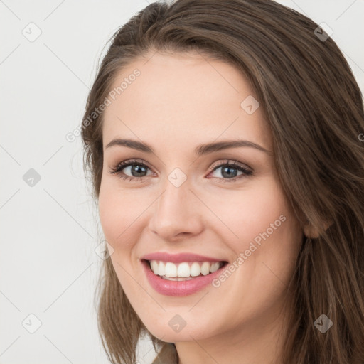 Joyful white young-adult female with long  brown hair and green eyes