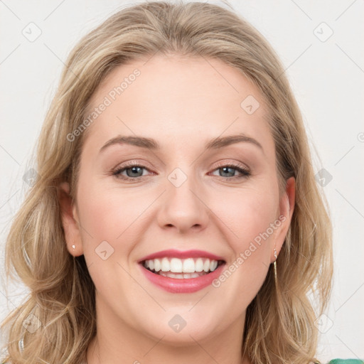 Joyful white young-adult female with long  brown hair and green eyes