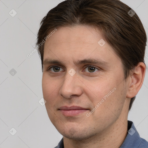 Joyful white adult male with short  brown hair and grey eyes