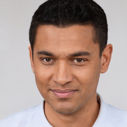 Joyful white young-adult male with short  black hair and brown eyes