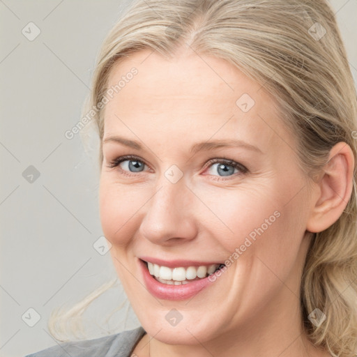 Joyful white young-adult female with medium  brown hair and blue eyes