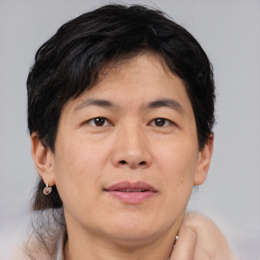Joyful asian adult male with medium  brown hair and brown eyes