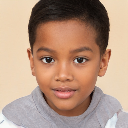 Joyful black child male with short  brown hair and brown eyes