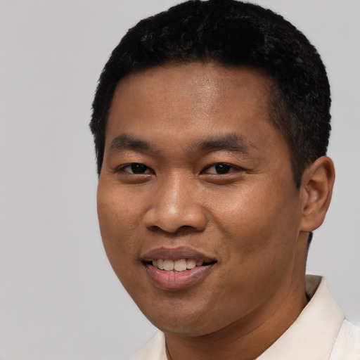 Joyful asian young-adult male with short  black hair and brown eyes