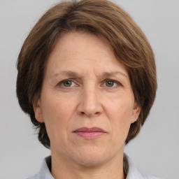 Joyful white middle-aged female with medium  brown hair and grey eyes