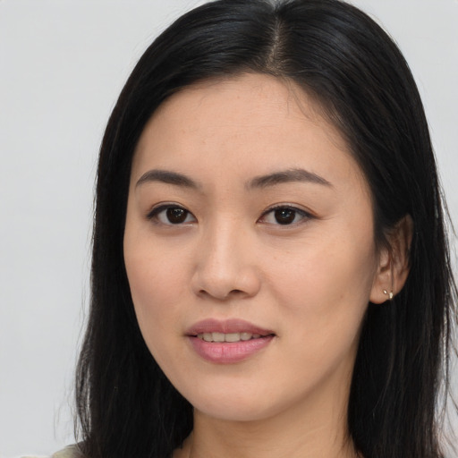 Joyful asian young-adult female with long  brown hair and brown eyes