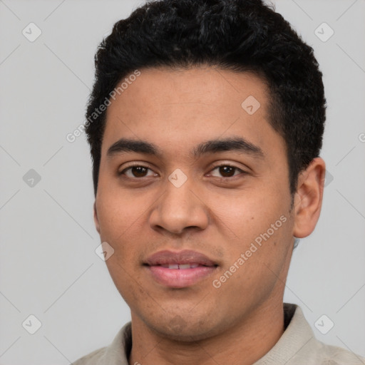 Joyful latino young-adult male with short  black hair and brown eyes