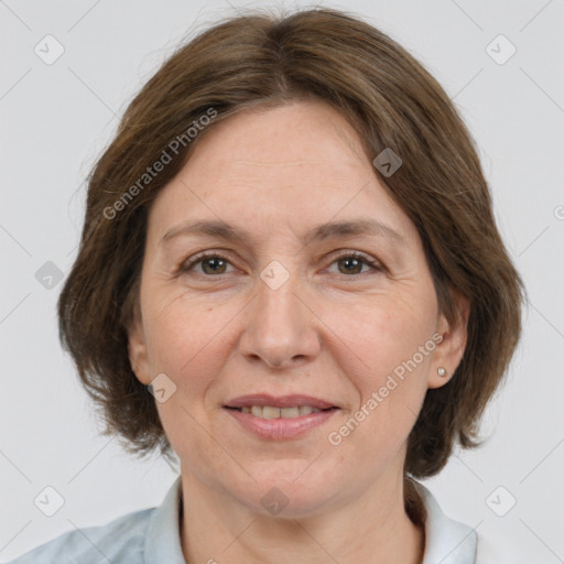 Joyful white adult female with medium  brown hair and grey eyes