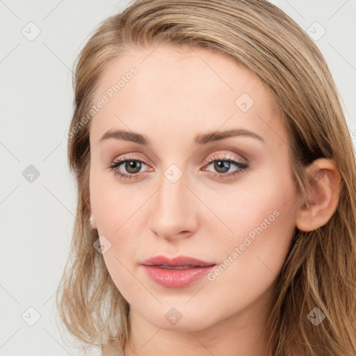 Joyful white young-adult female with long  brown hair and blue eyes