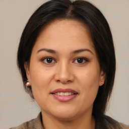 Joyful latino young-adult female with medium  brown hair and brown eyes