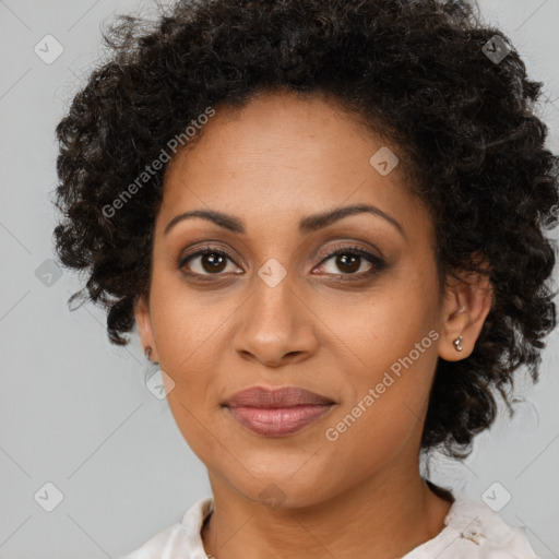 Joyful black adult female with medium  brown hair and brown eyes