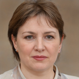 Joyful white adult female with medium  brown hair and grey eyes