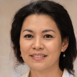 Joyful asian adult female with medium  brown hair and brown eyes