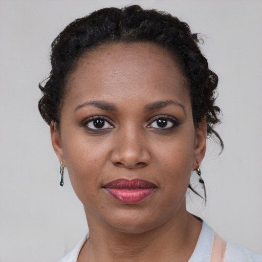Joyful black young-adult female with short  brown hair and brown eyes