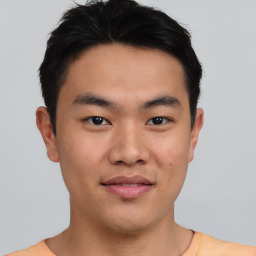 Joyful asian young-adult male with short  black hair and brown eyes