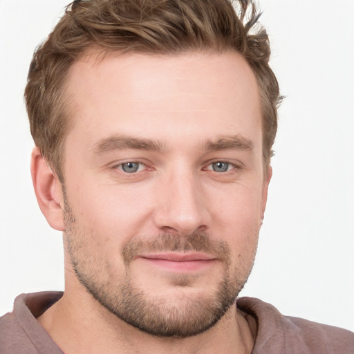 Joyful white young-adult male with short  brown hair and grey eyes