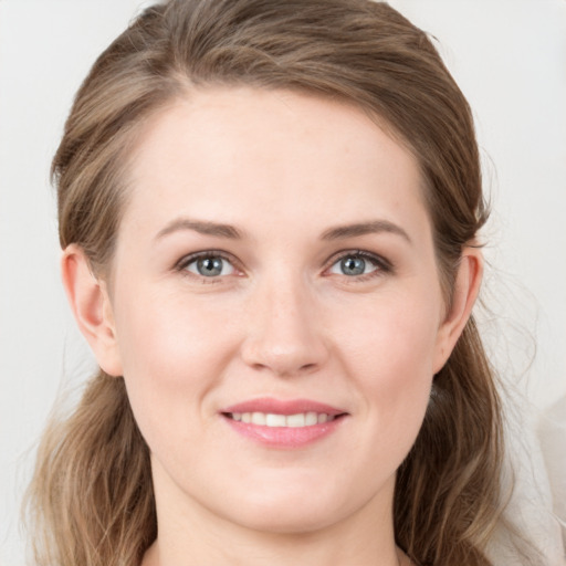 Joyful white young-adult female with medium  brown hair and grey eyes