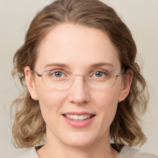 Joyful white young-adult female with medium  brown hair and green eyes