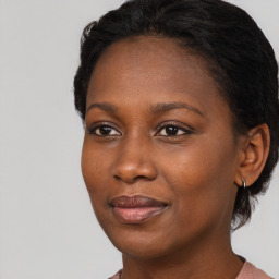 Joyful black young-adult female with medium  brown hair and brown eyes