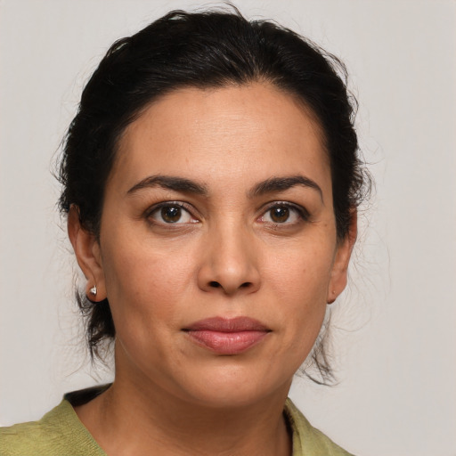 Joyful latino young-adult female with medium  brown hair and brown eyes