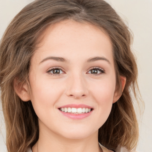 Joyful white young-adult female with long  brown hair and green eyes