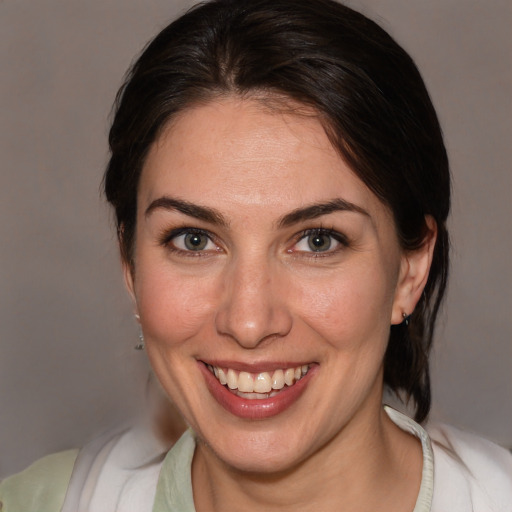 Joyful white adult female with medium  brown hair and brown eyes