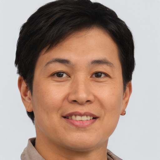 Joyful asian adult female with short  brown hair and brown eyes