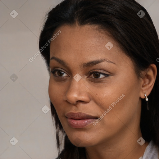 Joyful black young-adult female with long  brown hair and brown eyes