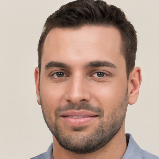 Joyful white young-adult male with short  brown hair and brown eyes