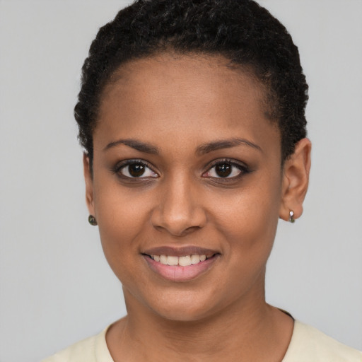 Joyful black young-adult female with short  black hair and brown eyes