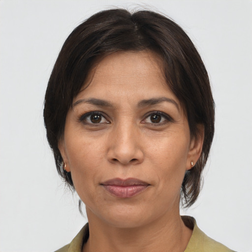 Joyful white adult female with medium  brown hair and brown eyes