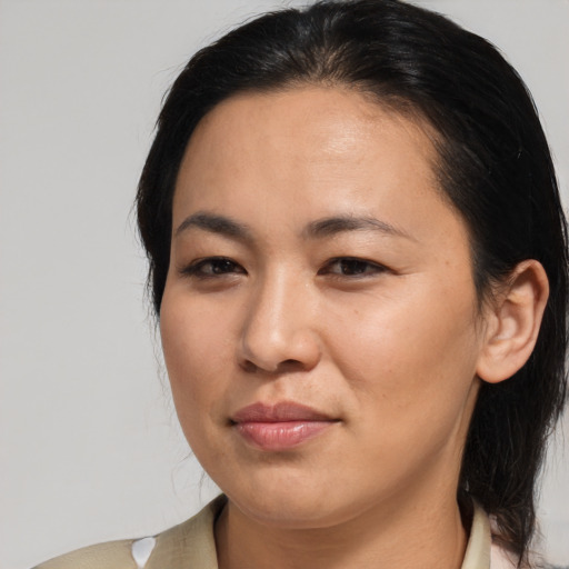 Joyful asian adult female with medium  brown hair and brown eyes