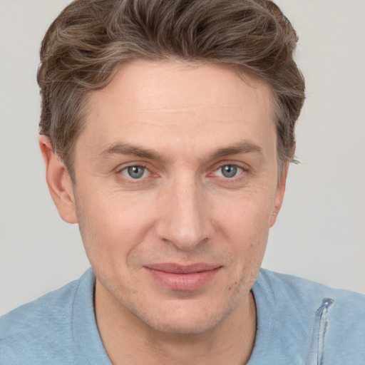 Joyful white adult male with short  brown hair and grey eyes