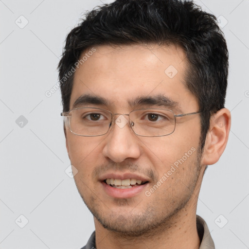 Joyful white young-adult male with short  black hair and brown eyes