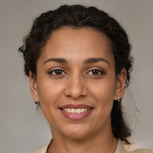 Joyful white adult female with medium  brown hair and brown eyes