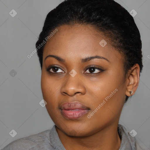 Joyful black young-adult female with short  black hair and brown eyes