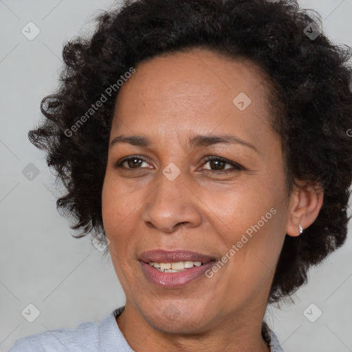 Joyful black adult female with medium  brown hair and brown eyes