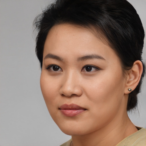 Joyful asian young-adult female with medium  brown hair and brown eyes