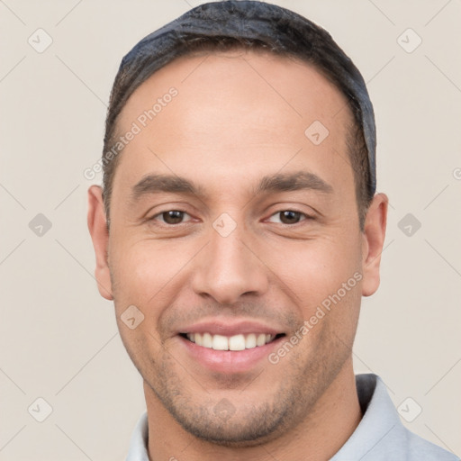 Joyful white young-adult male with short  black hair and brown eyes