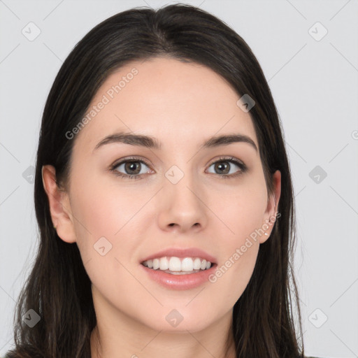 Joyful white young-adult female with long  black hair and brown eyes