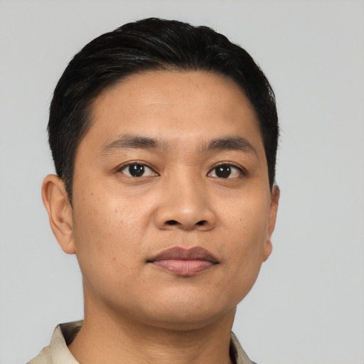 Joyful asian young-adult male with short  black hair and brown eyes