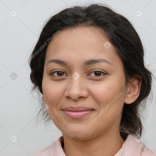 Joyful latino young-adult female with medium  brown hair and brown eyes