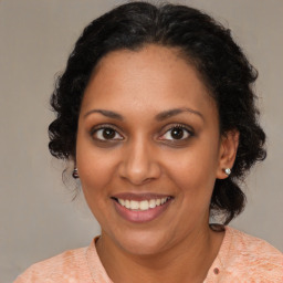 Joyful black young-adult female with medium  brown hair and brown eyes