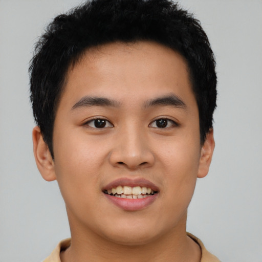 Joyful asian young-adult male with short  black hair and brown eyes