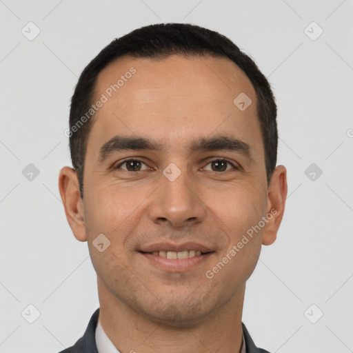 Joyful white young-adult male with short  black hair and brown eyes