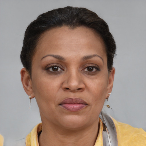 Joyful latino adult female with short  brown hair and brown eyes
