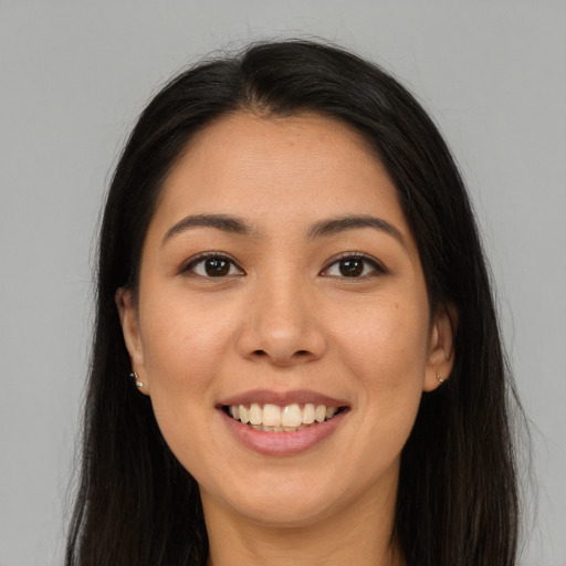 Joyful latino young-adult female with long  brown hair and brown eyes