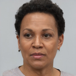 Joyful black adult female with short  brown hair and brown eyes