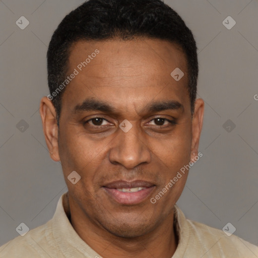 Joyful latino adult male with short  brown hair and brown eyes